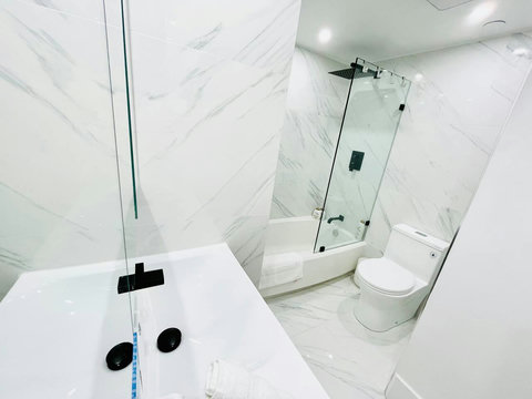 Refresh and rejuvenate in Bathroom Nr 1, featuring a shower and bathtub combination, complemented by elegant dual sinks.
