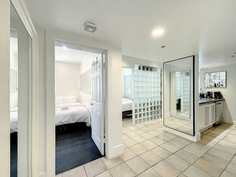 Embrace the South Beach Miami Beach vibe! Bright and airy with seven windows, glass blocks, and oversized Art Deco designed mirrors. Your historic retreat awaits. 