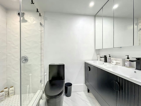Your oasis of relaxation! Experience contemporary bathrooms with dimmer lights, double sink vanity, shower, & mirrored wall cabinets.
