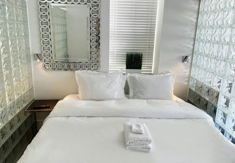 Rest in comfort! Discover a bedroom with memory foam mattresses, cozy dimmer lighting, USB chargers, Designer Mirrors, and Art Deco glass design.
