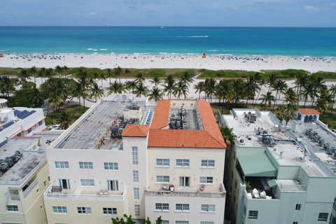 Escape to Casa Grande South Beach SoBeSuites (Red Mediteranean tile roof as seen in this photo), located right on Lummus Park Beach, Ocean Drive! Experience beachfront bliss like never before. Inquire now for more info.  