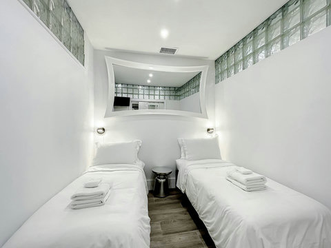 Rest in comfort! Discover a bedroom with memory foam mattresses, cozy dimmer lighting, USB chargers, Designer Mirrors, and Art Deco glass design.
