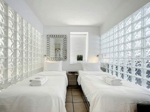 Rest in comfort! Discover a bedroom with memory foam mattresses, cozy dimmer lighting, USB chargers, Designer Mirrors, and Art Deco glass design.
