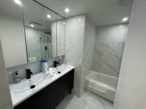 Refresh and rejuvenate in Bathroom Nr 1, featuring a shower and bathtub combination, complemented by elegant dual sinks.

