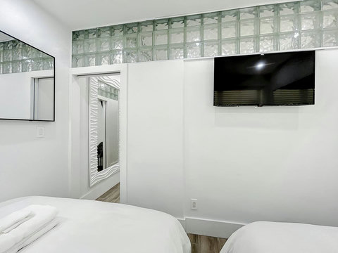 Rest in comfort! Discover a bedroom with memory foam mattresses, cozy dimmer lighting, USB chargers, Designer Mirrors, and Art Deco glass design.
