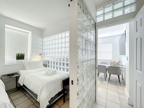 Rest in comfort! Discover a bedroom with memory foam mattresses, cozy dimmer lighting, USB chargers, Designer Mirrors, and Art Deco glass design.
