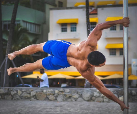 Welcome to our charming Casa Grande Suites building, adorned with Mediterranean-style clay tiles and cheerful yellow awnings, as seen in the background of this photo. The Beach Gym awaits right in front, courtesy of Muscle Beach South Beach.
