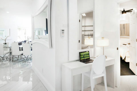 Step into a stylish entry foyer featuring a convenient laptop workstation and complimentary WiFi.