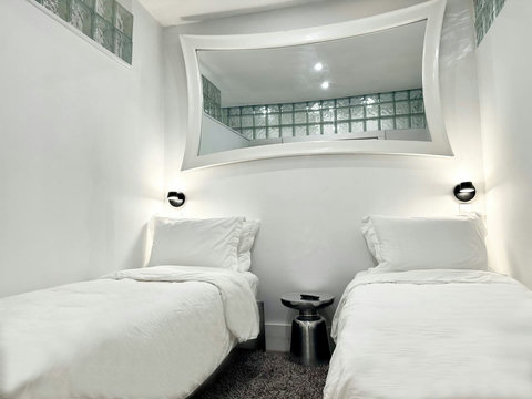 Rest in comfort! Discover a bedroom with memory foam mattresses, cozy dimmer lighting, USB chargers, Designer Mirrors, and Art Deco glass design.
