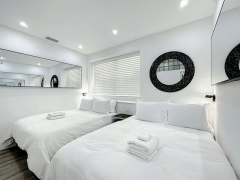 Rest in comfort! Discover a bedroom with memory foam mattresses, cozy dimmer lighting, USB chargers, Designer Mirrors, and Art Deco glass design.
