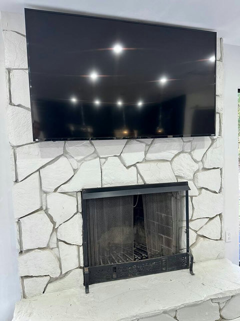 Relax by the fireplace while enjoying your favorite shows on the wide-screen TV.