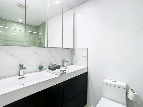 Bathroom with Bathtub and Shower combination and Dual Sinks.