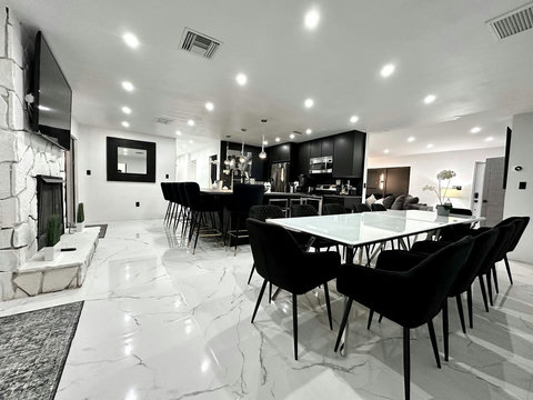 Open-plan kitchen and dining area with natural light and warm ambiance.
