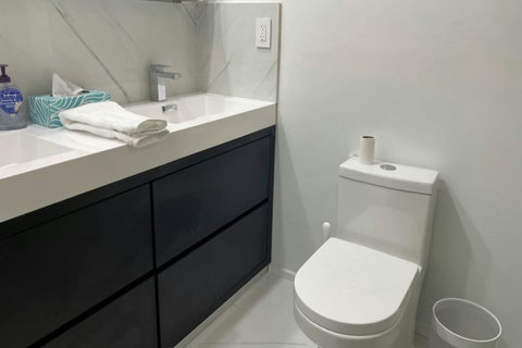 Bathroom with Bathtub and Shower combination and Dual Sinks.