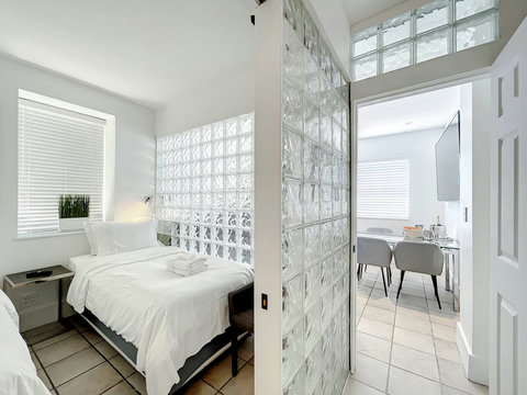 Charming Art Deco Vibes - This bright and airy space boasts six windows, glass blocks, and oversized Art Deco-designed mirrors, capturing the essence of historic South Beach Miami Beach.