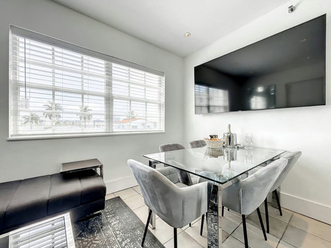 Relax in the bright living room with a large 75-in Smart TV and an oversized window offering a partial city view, away from any street noise. Gather around the dining table with comfortable chairs for delightful meals and great conversations.