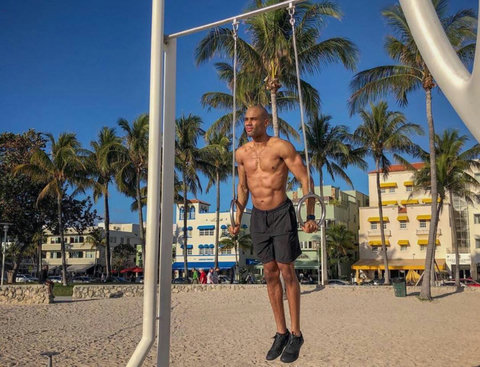 Welcome to our charming Casa Grande Suites building, adorned with Mediterranean-style clay tiles and cheerful yellow awnings, as seen in the background of this photo. The Beach Gym awaits right in front, courtesy of Muscle Beach South Beach.