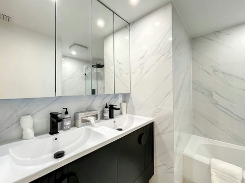 Refresh and rejuvenate in Bathroom Nr 1, featuring a shower and bathtub combination,
complemented by elegant dual sinks.