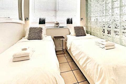 Ultimate Privacy - Experience complete seclusion in Bedroom 2, a completely private space with floor-to-ceiling walls and door, offering the choice of 1 King or 2 Single beds.