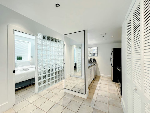 Charming Art Deco Vibes - This bright and airy space boasts six windows, glass blocks, and oversized Art Deco-designed mirrors, capturing the essence of historic South Beach Miami Beach.
