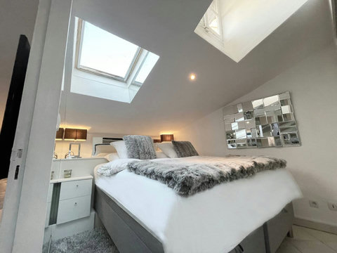 Embrace the beauty of natural light in our bedroom with ceiling windows. Wake up to stunning views and experience a serene stay like no other! 