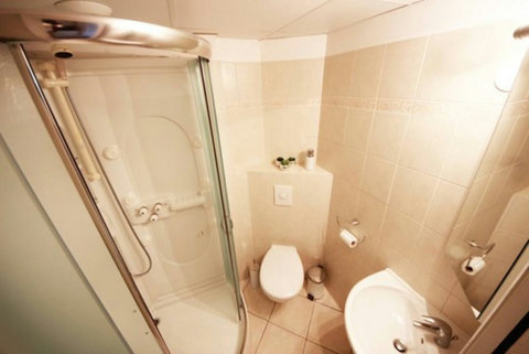 Indulge in convenience and comfort in our bathroom with a standing shower and washer & dryer. Enjoy a refreshing shower and seamless laundry experience during your stay.