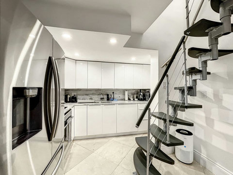 Fully equipped kitchen with stainless steel appliances, state-of-the-art induction cook-top, convection health cooking oven, built-in oven, Brazilian marble counter top, Nespresso cappuccino maker, Keurig coffee maker, brew coffee, and condiments. 