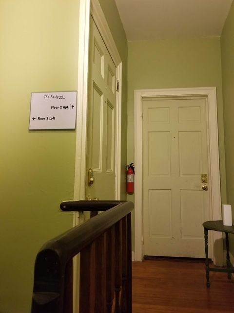 Top of the stairs, door to the 2nd floor apartment is straight ahead