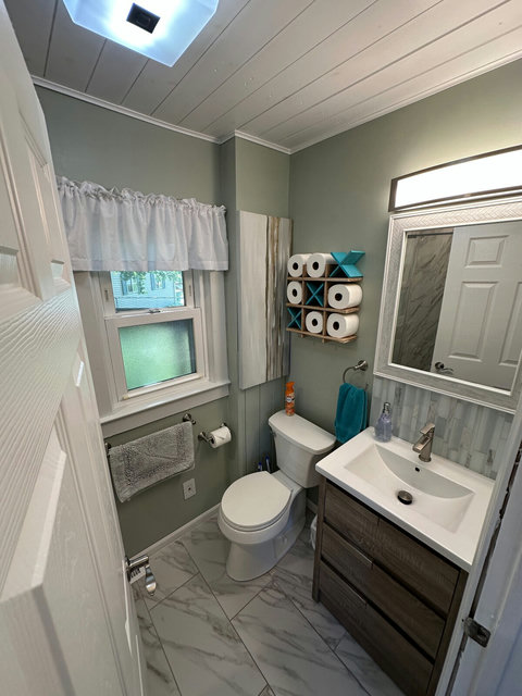 The newly-remodeled bathroom features ceramic tile throughout and all new fixtures, vanity and in-wall medicine cabinet.