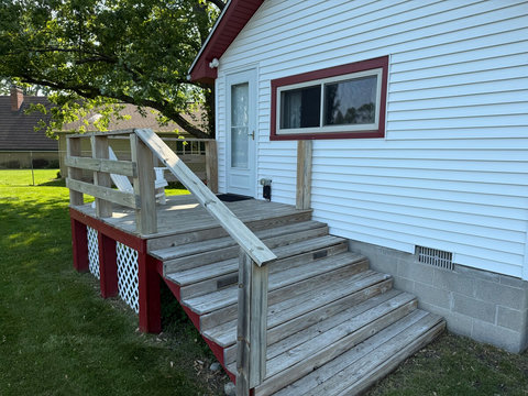 Back deck accessible from the master bedroom, featuring step lighting in the evening, and new entry/storm door with retractable screen.