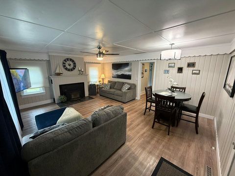 The freshly painted living room features a couch, loveseat, dining room table with high top chairs and expandable leaf. 

Enjoy the 58" 4K tv with 3.1 channel soundbar and wood burning fireplace insert.