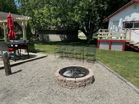 The firepit area features a peastone surface.