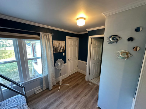 Guest/kids room with luxury vinyl tile flooring. Features a metal bunk bed with memory foam mattresses, linens and pillows - twin over full size beds.