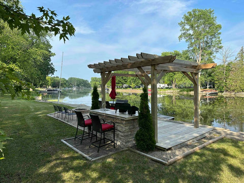 The dockside deck and pergola area, facing downstream toward Saginaw Bay, Castaways Bar & Grill, and much more!