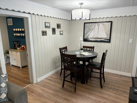 The freshly painted living room features a couch, loveseat, dining room table with high top chairs and expandable leaf. 

Enjoy the 58" 4K tv with 3.1 channel soundbar and wood burning fireplace insert.