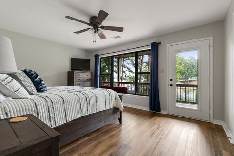 Third bedroom (located by bunk room) has king bed and lake views with direct access to lower balcony.