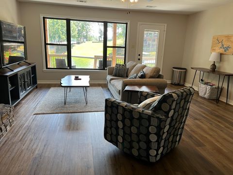 Downstairs living area. Direct access to lake and lower balcony provided from this area. (Fireplace currently nonfunctional in lower living area only.)