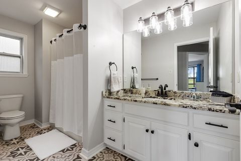 Wider angle of full bath downstairs with shower/tub combo (by bedroom #2)