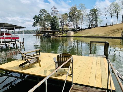 Swim dock with two Adirondack chairs and bench available for seating leaving space to lay out or play. Also nice area for playing or fishing in the lake. 
