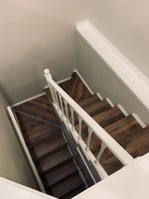 Stairs leading to lower level of home. Second living area, 2 full baths, 3 bedrooms, and lake access located on lower level of home