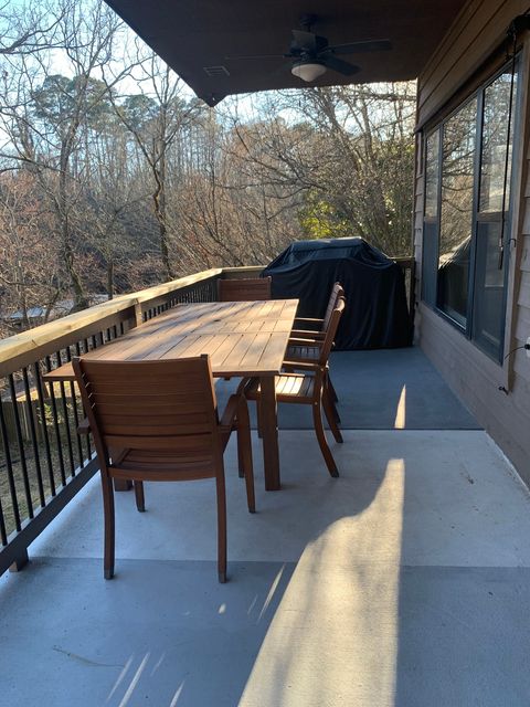 Outdoor dining table and propane gas grill available for use. 