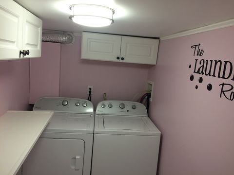 Laundry room with washer, dryer, and iron.