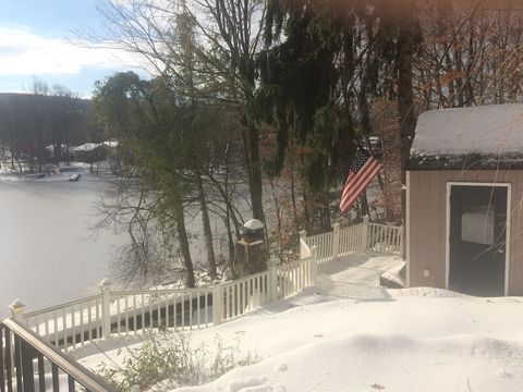 View from entrance door showing the lake and shed in winter