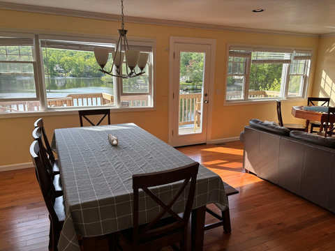 8-seater dining table in living room overlooking the lake
