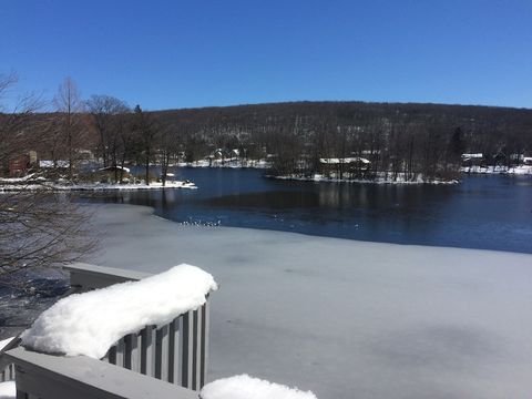 View from living room balcony in late fall with half of the lake frozen