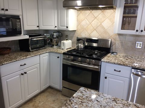 Stove, microwave, mini-oven, food mixer, toaster, blender, dishwasher, and more in the kitchen. 