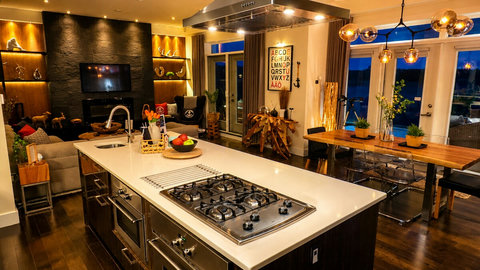 The Great Room is spacious yet warm and cozy, featuring a large dining table for 6 and an expansive island. It opens directly onto the sunlit heated pool, offering breathtaking panoramic views of Halifax Harbour.