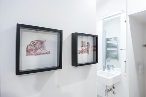 Marble bathroom with walk-in rain shower and 24-hour hot high-pressure water. Large mirror, hair dryer, free toiletries (shampoo, conditioner and body wash), high-quality branded towels, and heated towel rack are all included.
