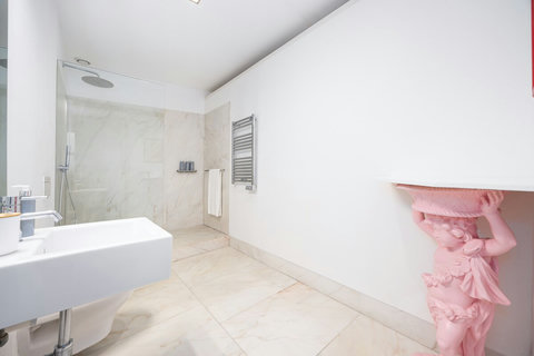 Large marble bathroom with walk-in rain shower. 24-hour high water pressure hot water. Toilet, bidet, washbasin and hair dryer.   Free toiletries : hand soap, shampoo, conditioner, and body soap and toilet paper.  Free quality towels.