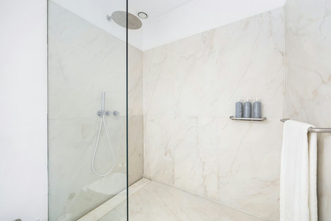 Large marble bathroom with walk-in rain shower. 24-hour high water pressure hot water. Toilet, bidet, washbasin and hair dryer.   Free toiletries : hand soap, shampoo, conditioner, and body soap and toilet paper.  Free quality towels.